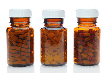 Three Brown Medicine Bottles With Different Drugs