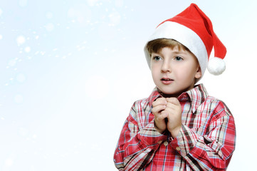 boy in santa claus hat on white background