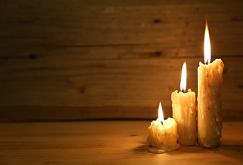  Burning old candle on wooden vintage background. 