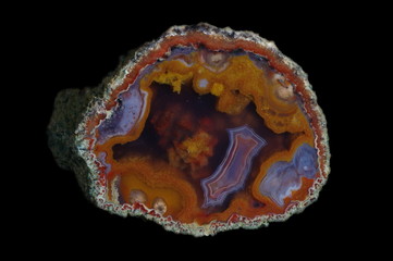 A cross section of agate stone with geode on a black background.  Origin:  Morocco, Asni.