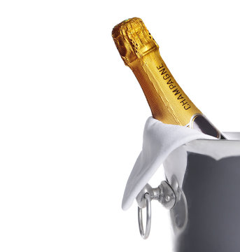Bottle of champagne in cooler over white