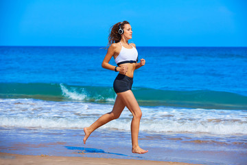 Fototapeta na wymiar Beautiful brunette girl running in a summer beach