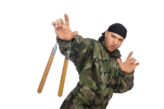 Young man in soldier uniform holding nunchaks isolated on white