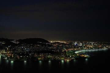 Fototapeta na wymiar Photo of the city at night taken during sightseeing on Sugarloaf mountain in Rio de Janeiro, Brazil.