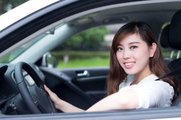 Beautiful young asian woman driving car