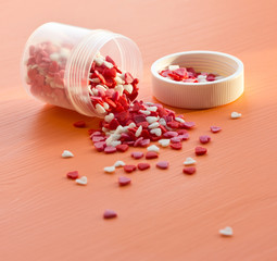 Colorful sugar sprinkles on a wooden table