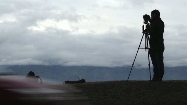 fot&oacute;grafo en medio de la autopista tomando fotos al paisaje