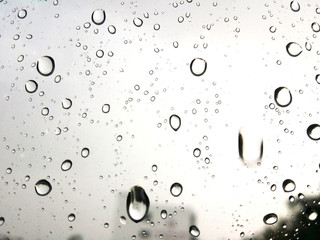 Rain Water droplets on glass window with blurred background. Raindrops. Water drops.