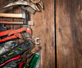 Set of different tools on wooden background