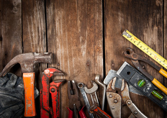 Set of different tools on wooden background