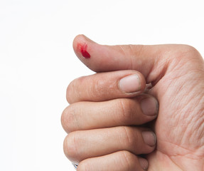 wounded finger with blood dripping isolated on white