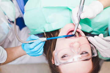 Young woman patient with dental braces in dentist chair looking