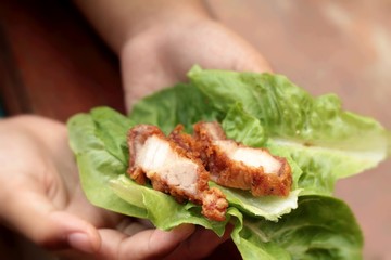 Pork fried with vegetables in hand.