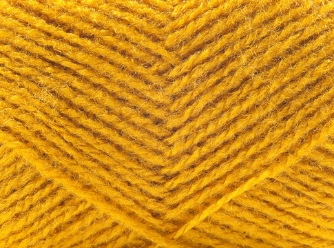 Yellow wool yarn isolated on white background