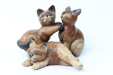 Thailand carved wooden cats on a white background.