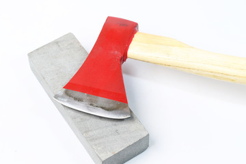 Stone sharpening an ax on a white background.