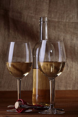 Two bocals and bottle of white wine