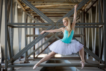 Graceful ballerina in the industrial background