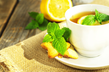Cup of tea with slice of lemon and home made cookies. Selective focus