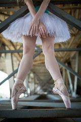 Cropped picture legs of graceful ballerina in white tutu