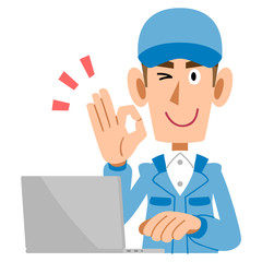 OKのサインを出す作業着の男性とノートパソコン