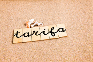 Words formed from small pieces of wood containing a sun and beach tourist destination, Tarifa