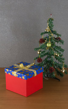 gift box and christmas tree on wood table
