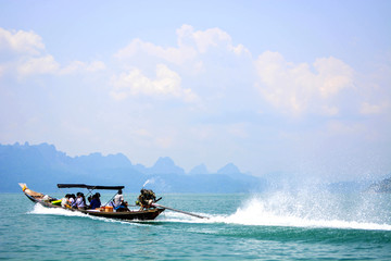 Fototapeta premium passenger wooden boat in tourist business in Thailand floating on sea water at Krabi in the South of Thailand