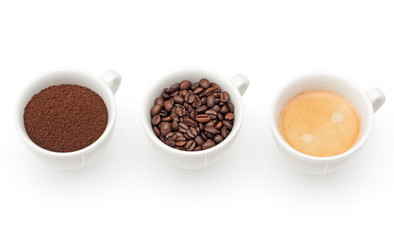 drei Tassen mit Kaffee, Kaffeebohnen und Kaffeepulver