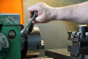 man working by a lathe