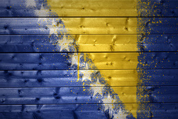 painted bosnian flag on a wooden texture