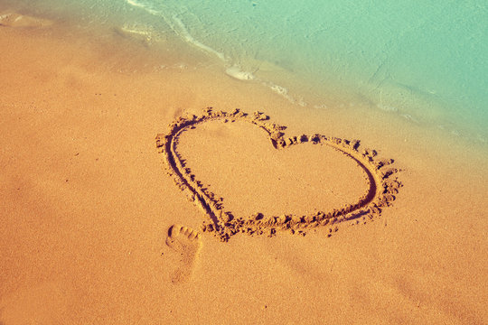 inscription heart on beach sand