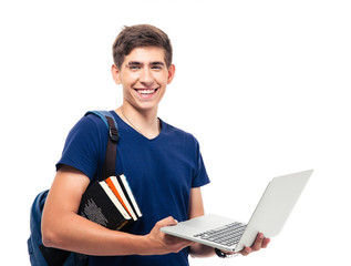 Happy male student with backpack and books holding laptop isolated on a white background. Looking...
