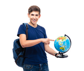 Smiling male student pointing finger on globe