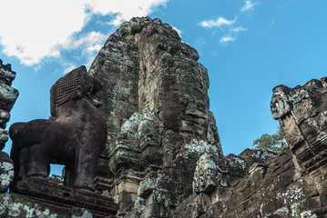 Fototapeta na wymiar lion and tower like metaphor of the mount meru with the head of lokeshvara and the face of jayavarman VII in the complex of the bayon in the archaeological angkor thom place in siam reap, cambodia