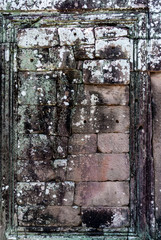texture with rocks of a blind door in the complex of the bayon in the archaeological angkor thom place in siam reap, cambodia