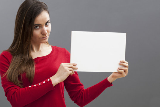 appealing young woman with a red sweater holding a blank message on board for seductive communication