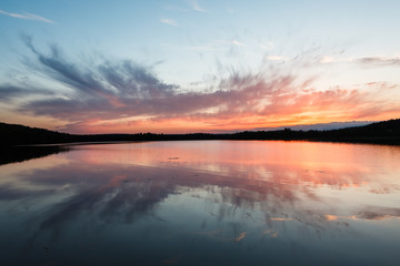 Fototapeta na wymiar Colorful sunset and reflection at lake