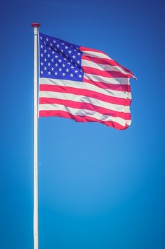 American flag on the blue sky - retro and vintage style