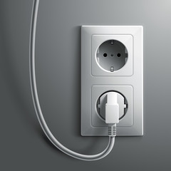 Electric white plug and socket on grey wall background