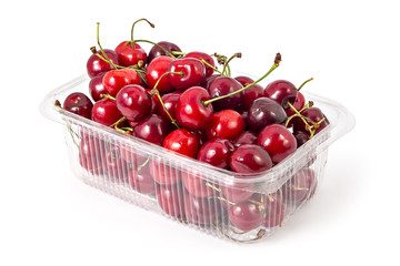Box or punnet of fresh ripe organic cherries isolated on white background