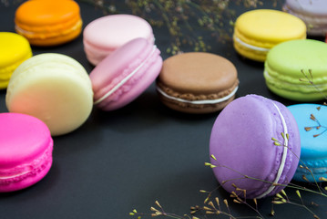 Macaron in a wooden box on black, Vintage tone