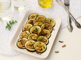 Antipasto of grilled courgette zucchini with olive oil and pine