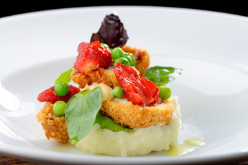 Fine dining, Fried Octopus on potato purree, green peas and fresh strawberries