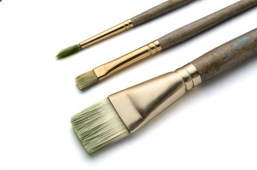 Three art paint brushes on white