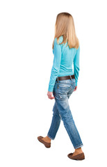 side view of walking  woman in jeans.