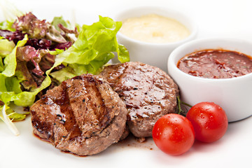 Barbecue Beef Steaks medium grilled with white and red sauces, l