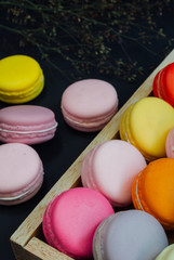 Macaron in a wooden box on black, Vintage tone