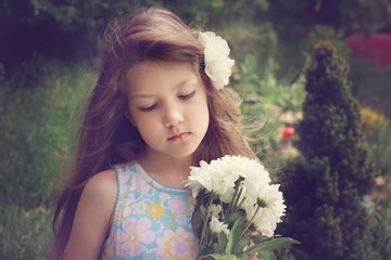 Vintage portrait of pretty little girl with flowers