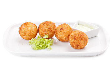 Deep fried cheese balls with lettuce and sauce.